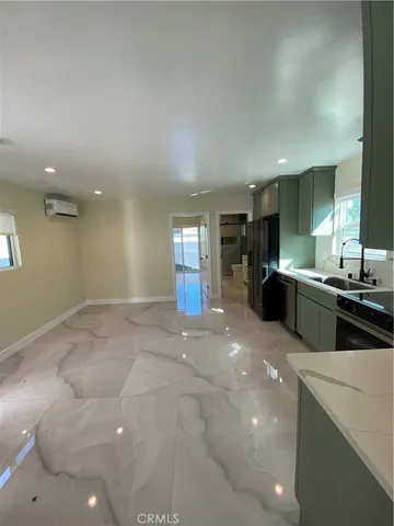 a view of a kitchen with a sink and cabinets