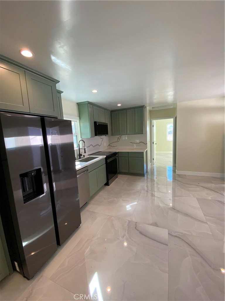 18020 Welby Reseda, CA 91335 - Photo 6 of 16 a kitchen with stainless steel appliances granite countertop a refrigerator and a sink