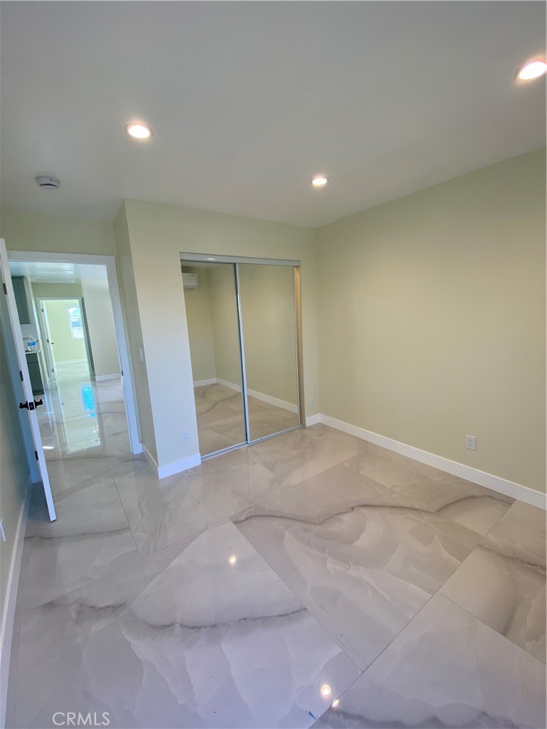18020 Welby Reseda, CA 91335 - Photo 8 of 16 an empty room with wooden floor and white walls