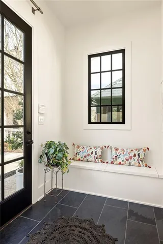a living room with furniture and a painting on the wall