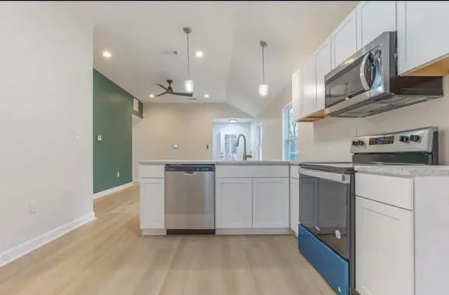 a view of a kitchen with a sink and a window