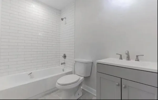 an empty room with wooden floor and a hallway