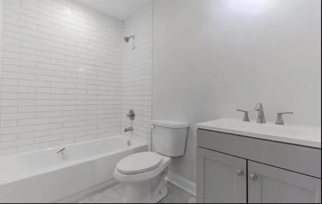 an empty room with wooden floor and a hallway