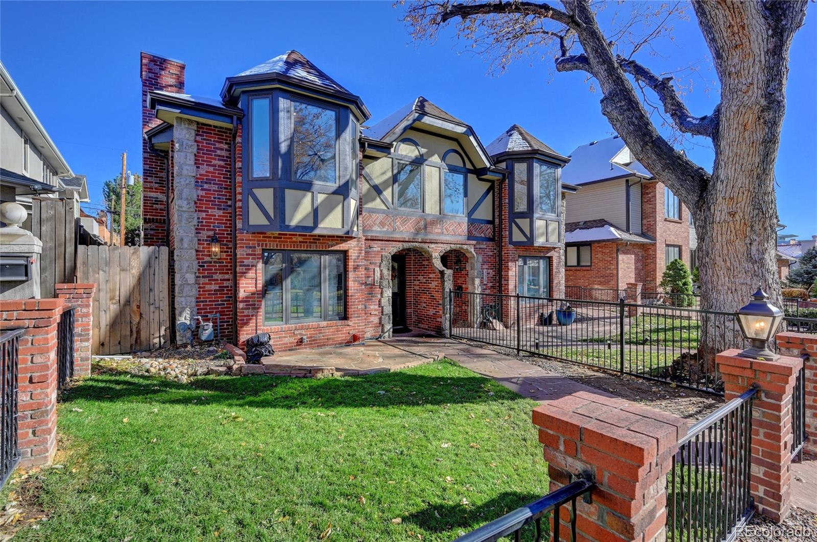 358 Steele Street Denver, CO 80206 - Photo 1 of 30 front view of a house with a yard