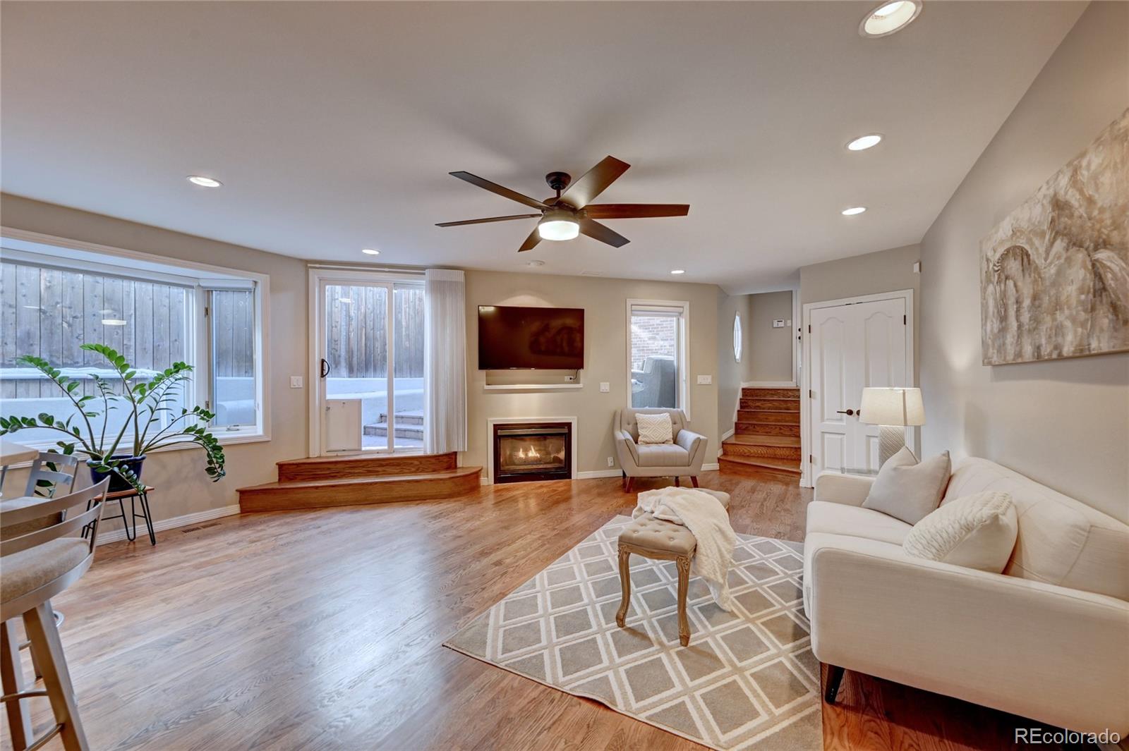 358 Steele Street Denver, CO 80206 - Photo 12 of 30 a living room with furniture a fireplace and a flat screen tv
