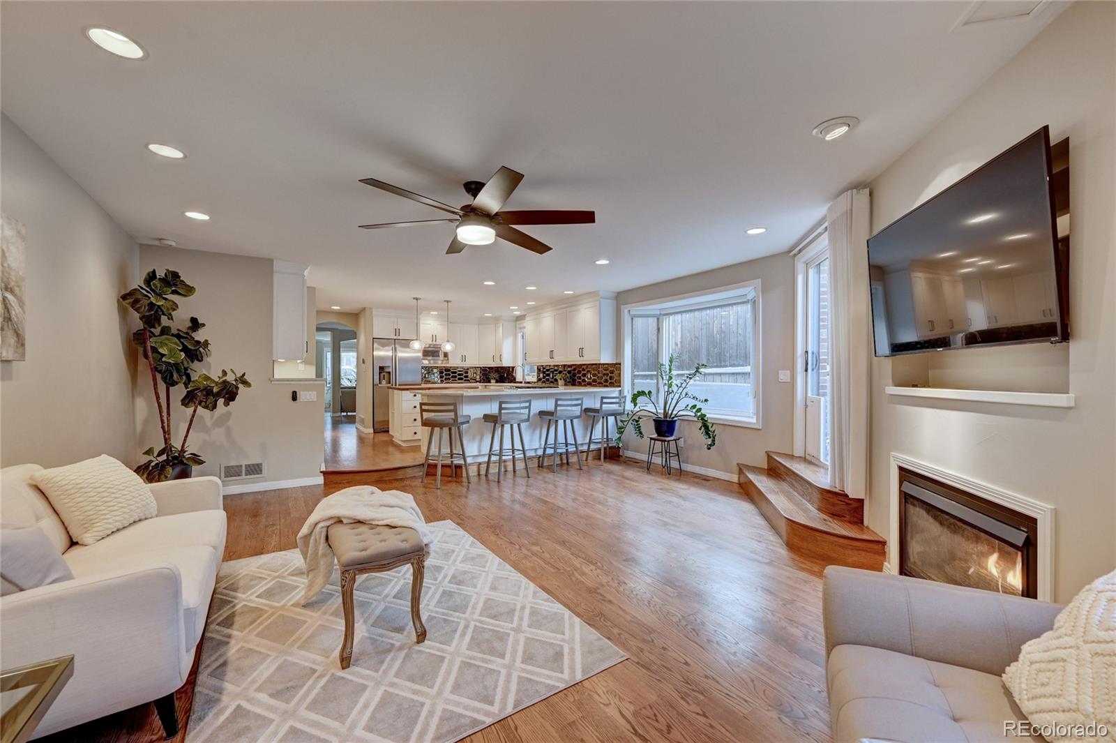 358 Steele Street Denver, CO 80206 - Photo 13 of 30 a living room with furniture and a flat screen tv