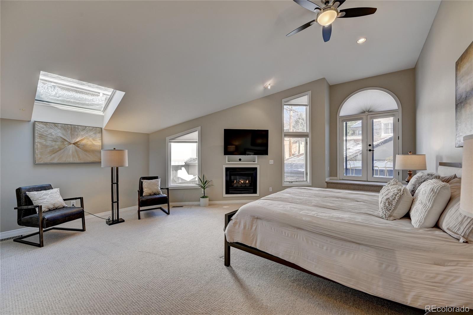 358 Steele Street Denver, CO 80206 - Photo 14 of 30 a spacious bedroom with a bed couch and a window