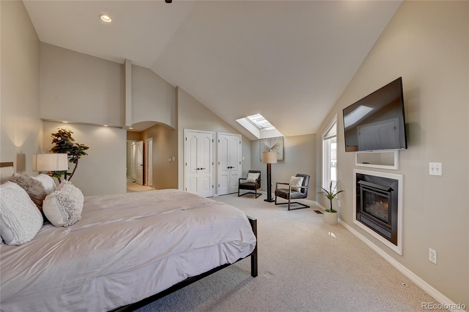 358 Steele Street Denver, CO 80206 - Photo 15 of 30 a spacious bedroom with a bed and a television