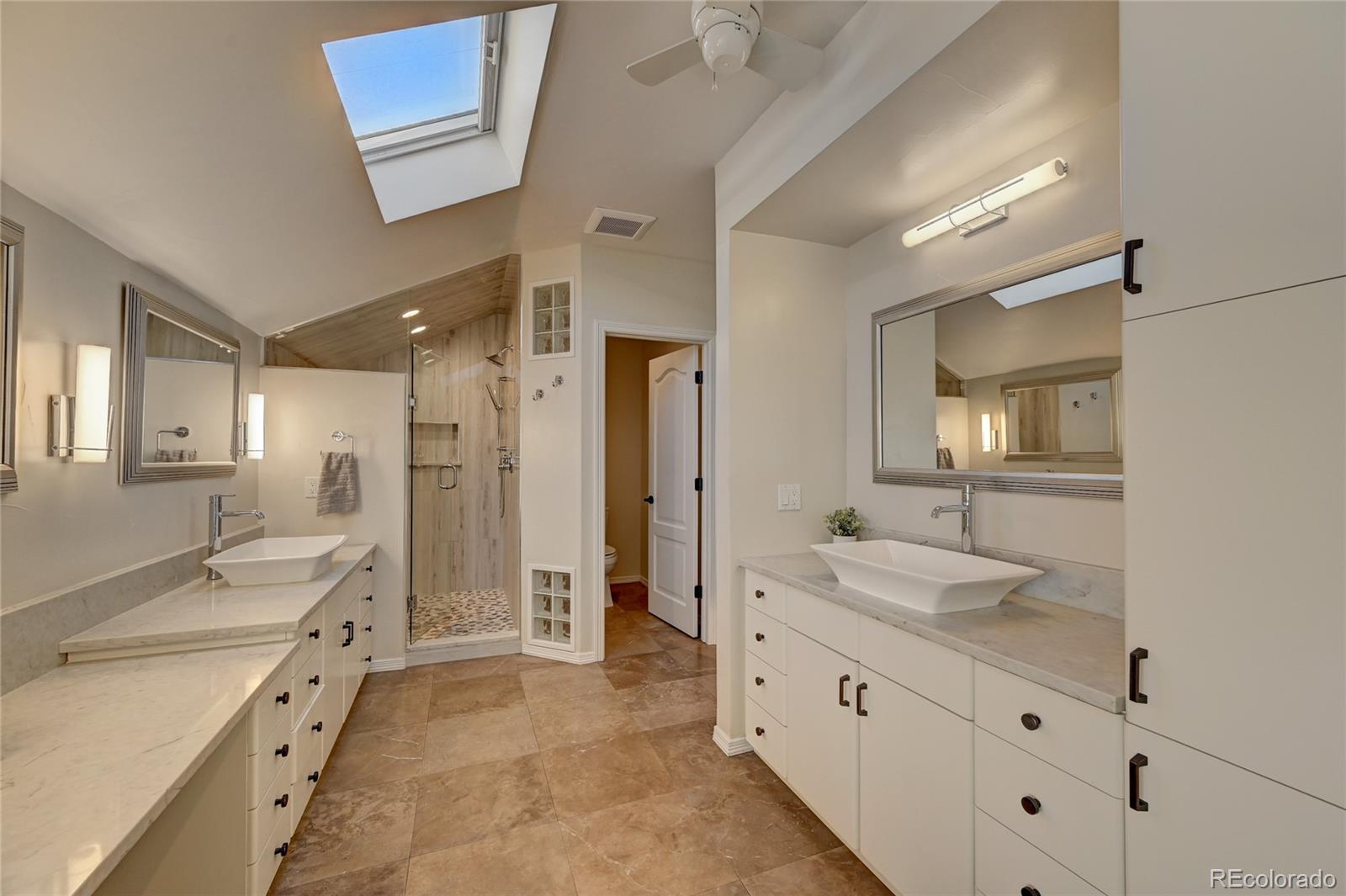 358 Steele Street Denver, CO 80206 - Photo 18 of 30 a spacious bathroom with double vanity sink a mirror a bathtub and shower