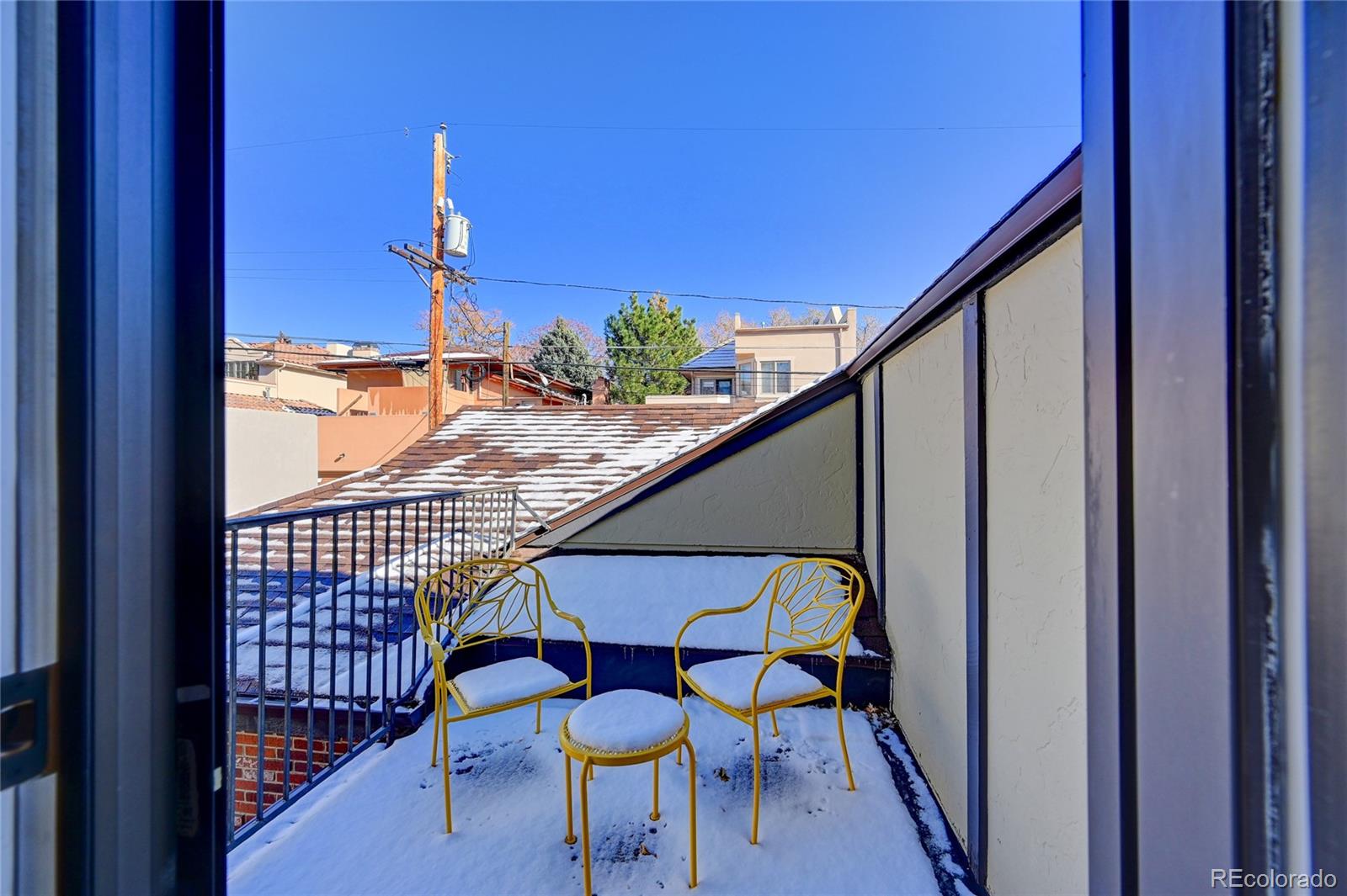 358 Steele Street Denver, CO 80206 - Photo 19 of 30 a balcony view with couple of chairs and wooden floor