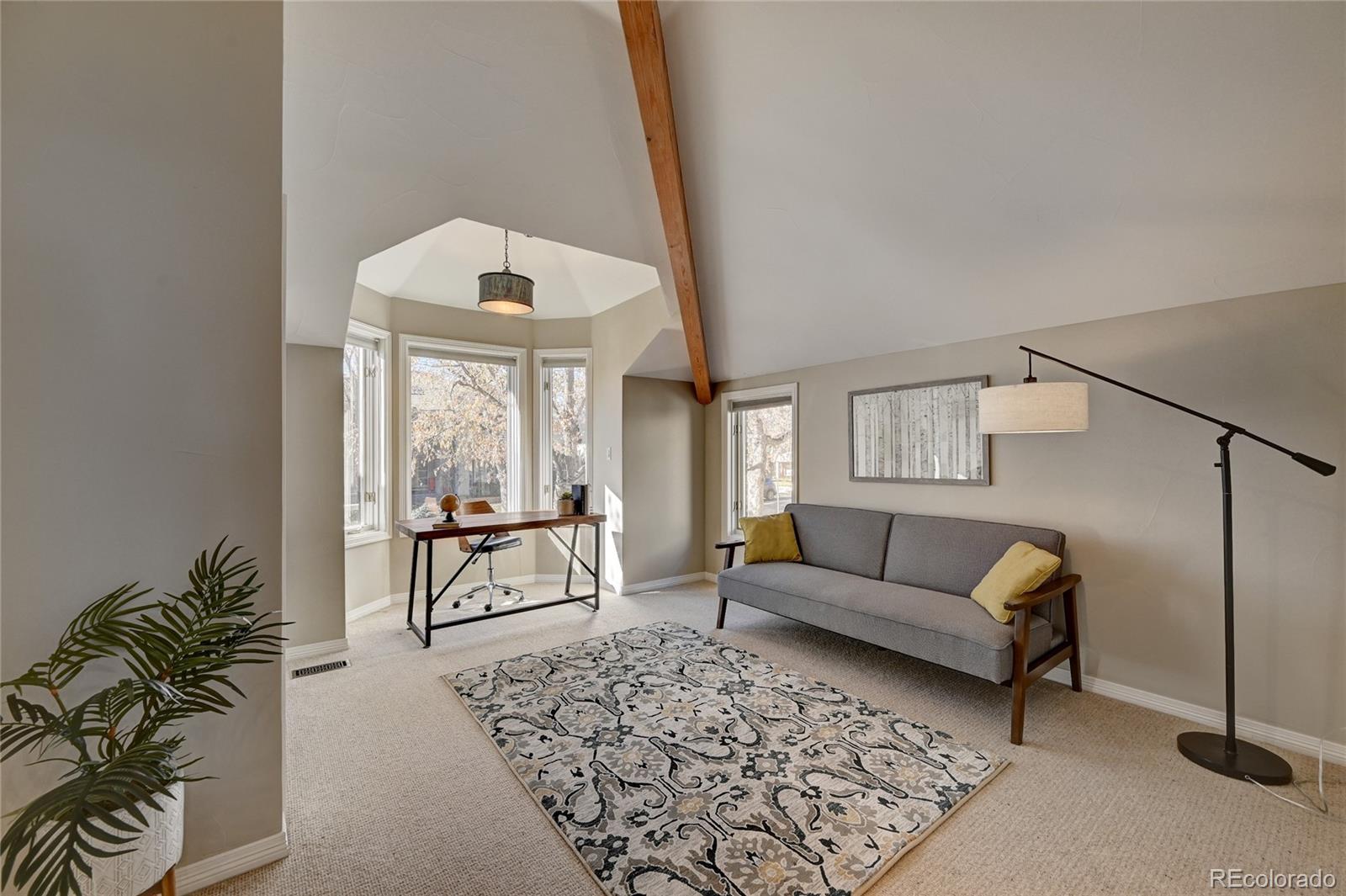 358 Steele Street Denver, CO 80206 - Photo 20 of 30 a living room with furniture and a large window