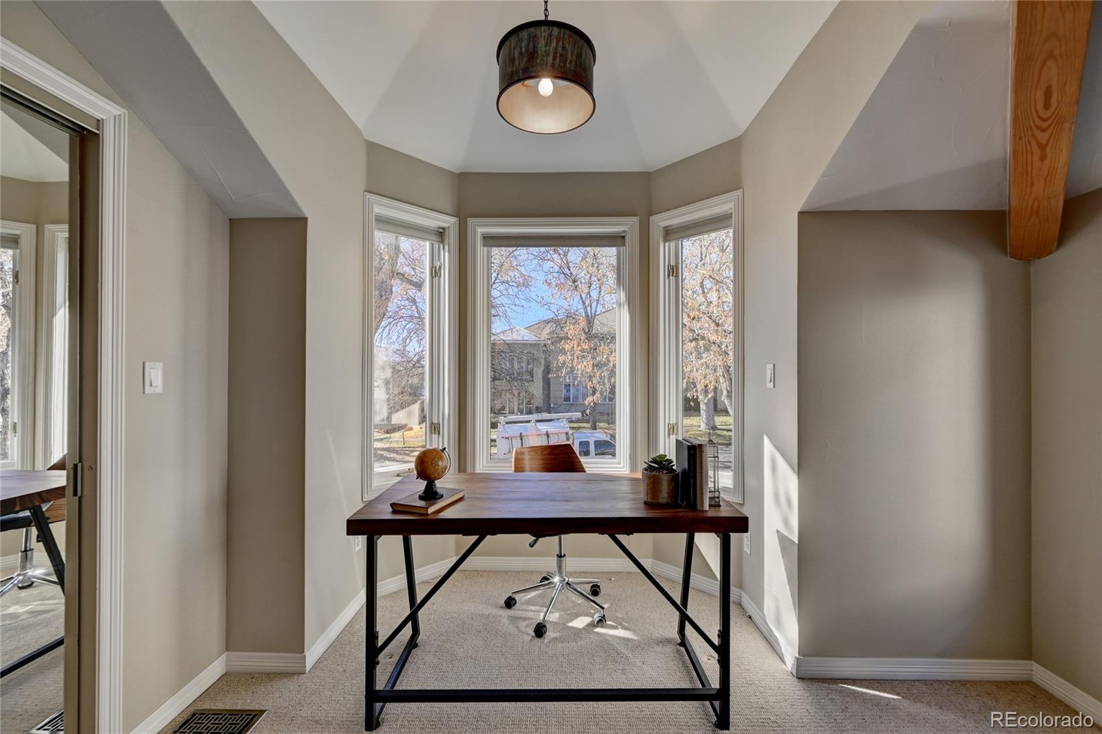 358 Steele Street Denver, CO 80206 - Photo 21 of 30 a living room with a couch and a window