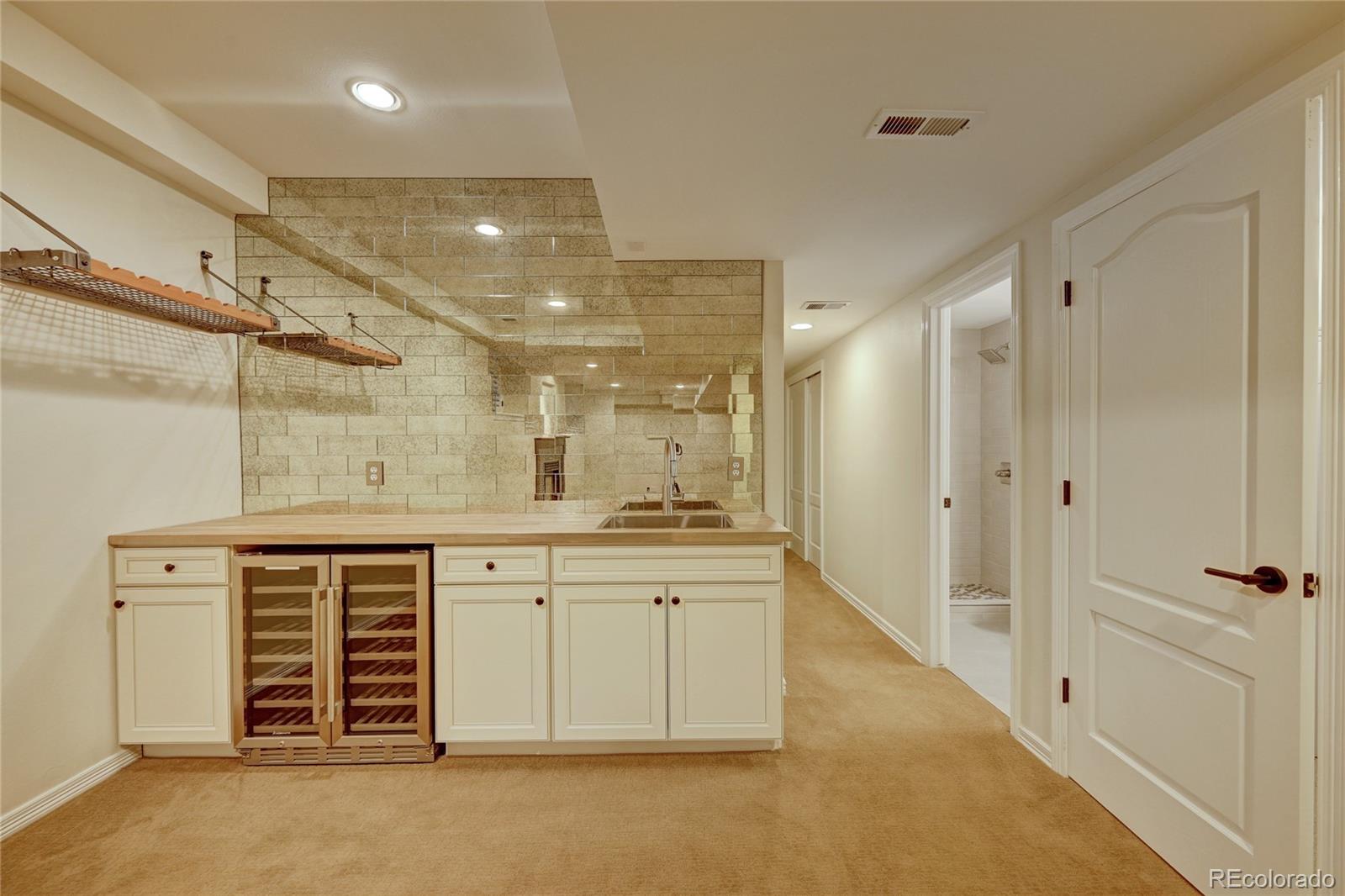 358 Steele Street Denver, CO 80206 - Photo 24 of 30 a spacious bathroom with a shower a sink and a mirror