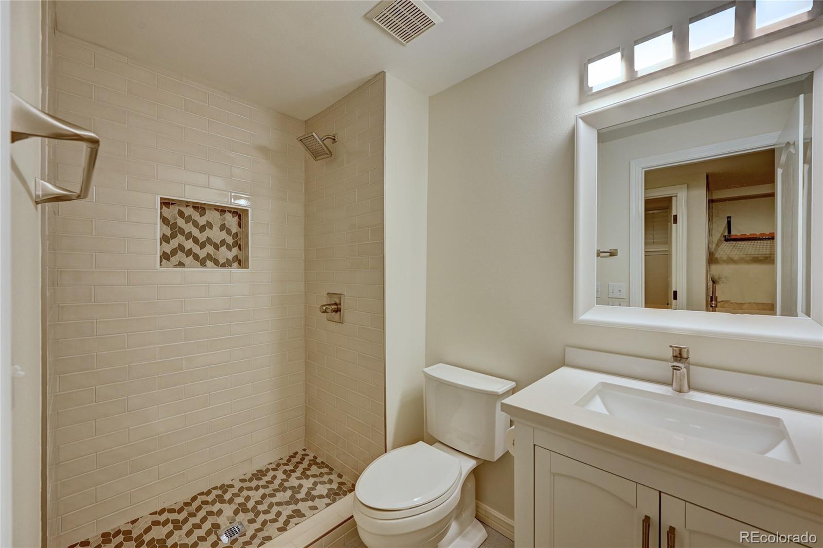 358 Steele Street Denver, CO 80206 - Photo 25 of 30 a bathroom with a sink a toilet and shower