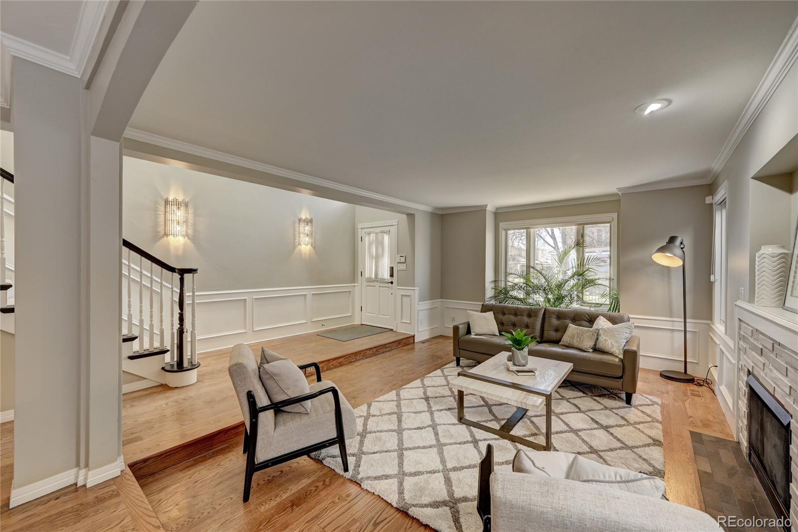 358 Steele Street Denver, CO 80206 - Photo 3 of 30 a living room with furniture and a fireplace
