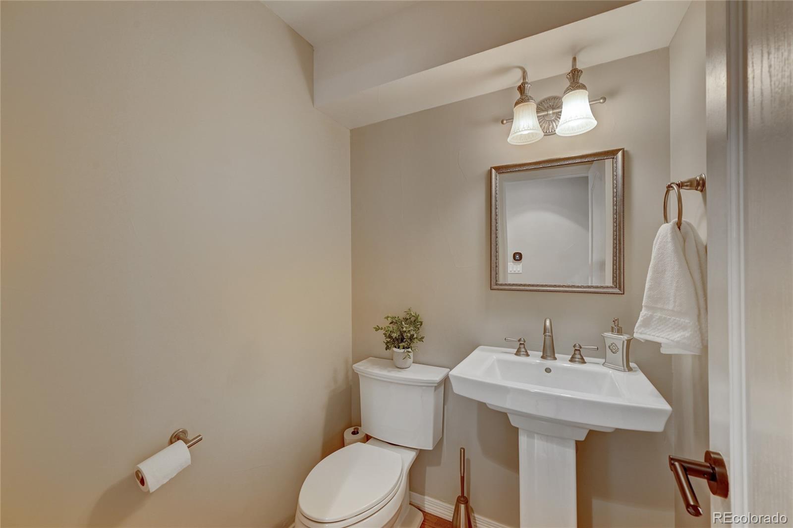 358 Steele Street Denver, CO 80206 - Photo 7 of 30 a bathroom with a sink a toilet and mirror