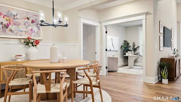 a view of a dining room with furniture and wooden floor