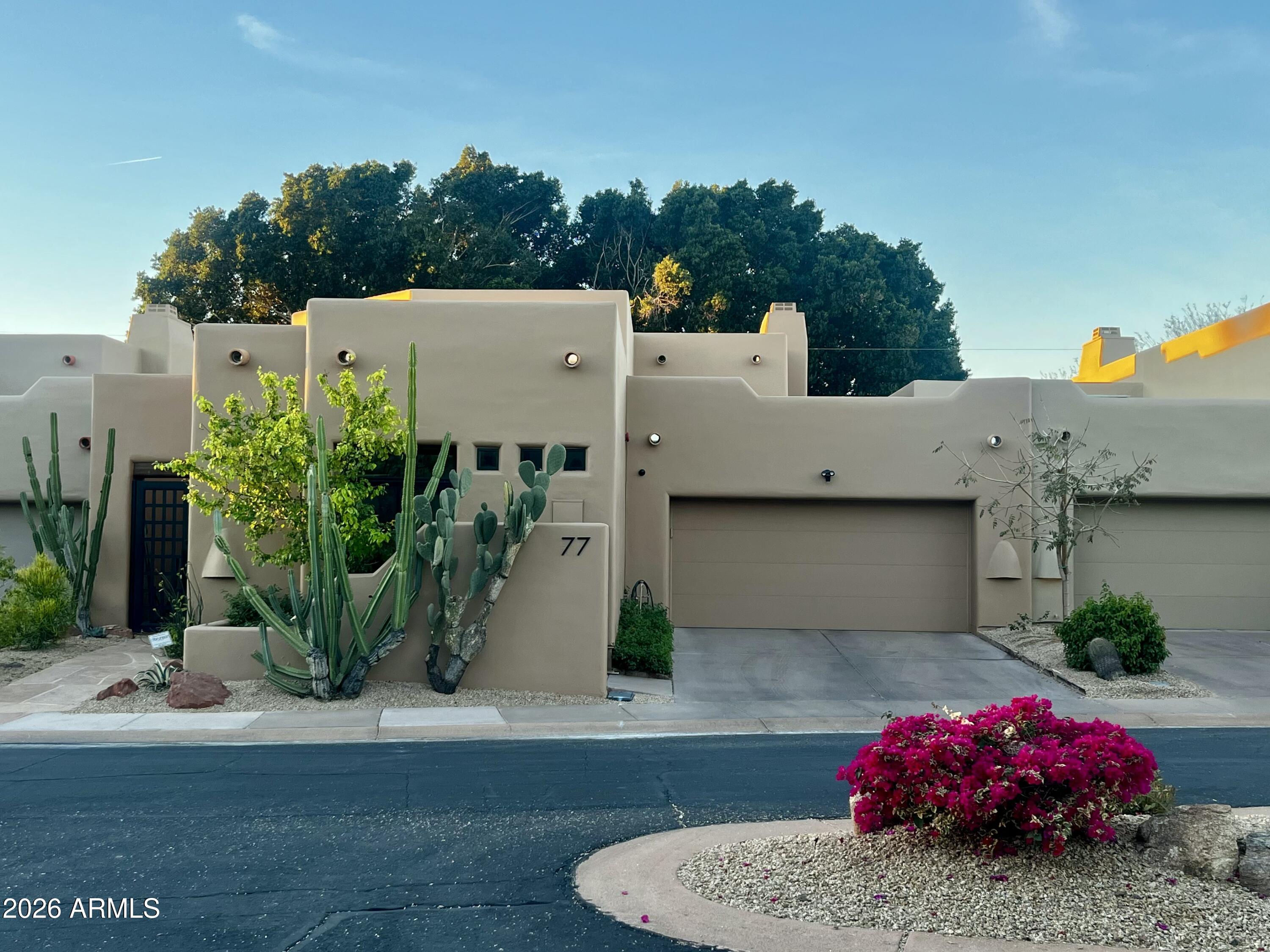 6711 East Camelback Road, Unit 77 Scottsdale, AZ 85251 - Photo 2 of 3 a view of a house with a garden