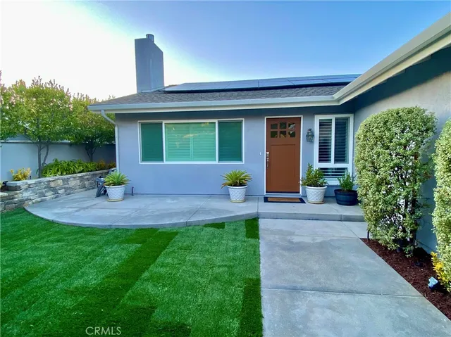 a front view of a house with a garden