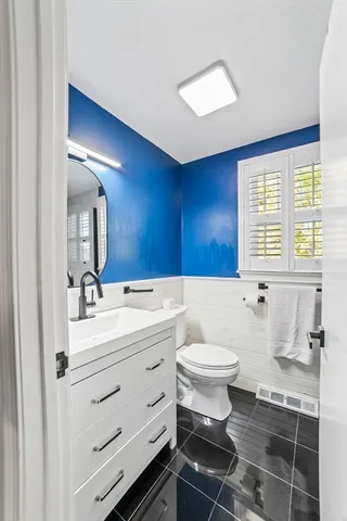 a bathroom with a sink toilet a mirror and bathtub