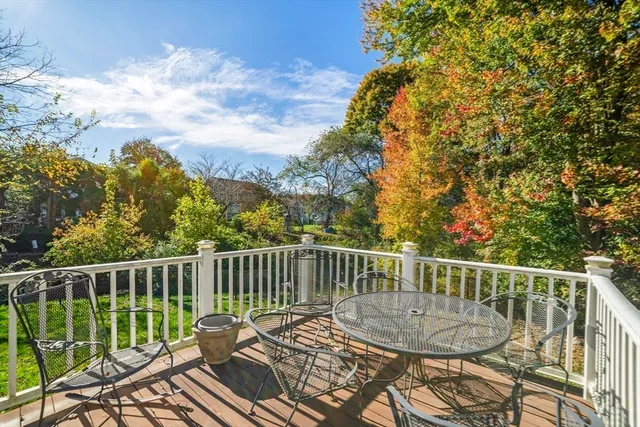 a view of a wooden deck and a backyard