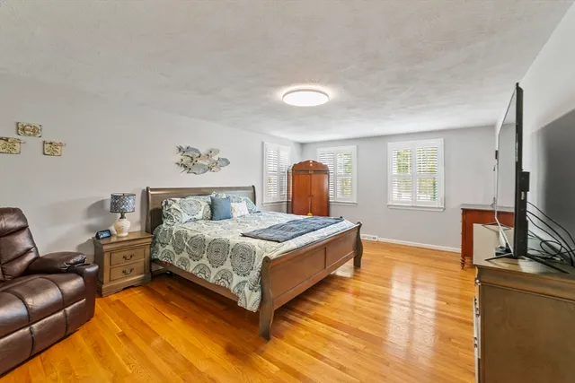 a bedroom with a bed and a flat screen television
