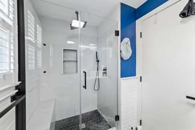 a bathroom with a shower vanity and a sink
