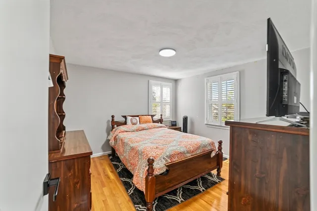 a bedroom with a bed and window