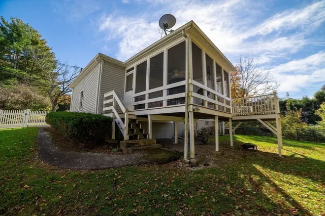 a view of backyard with potted plants and large tree