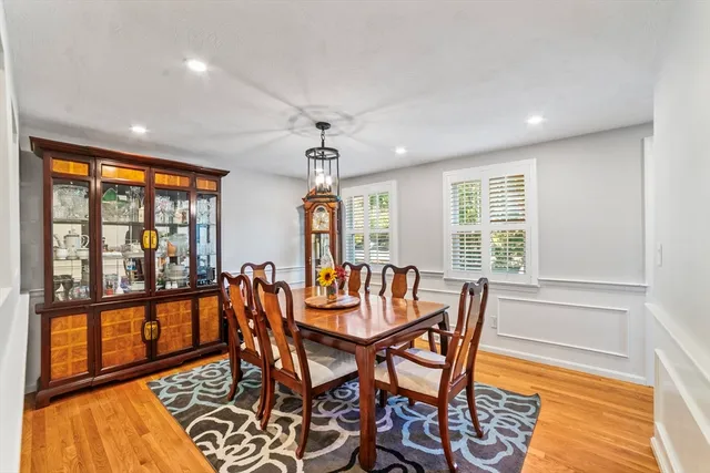 a dining room with furniture a chandelier and wooden floor
