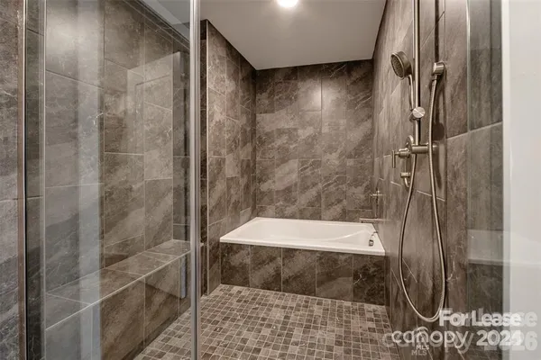 a bathroom with a bathtub and a shower