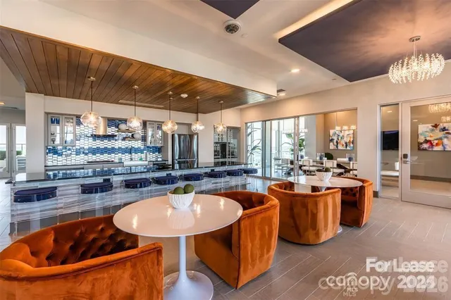 a kitchen with stainless steel appliances kitchen island granite countertop a sink and a large window