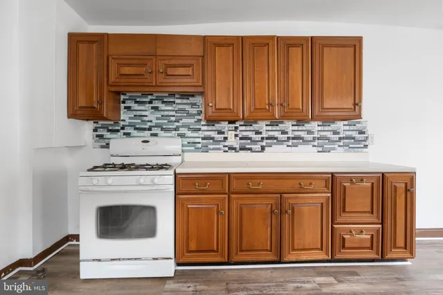 a kitchen with granite countertop cabinets sink and stainless steel appliances