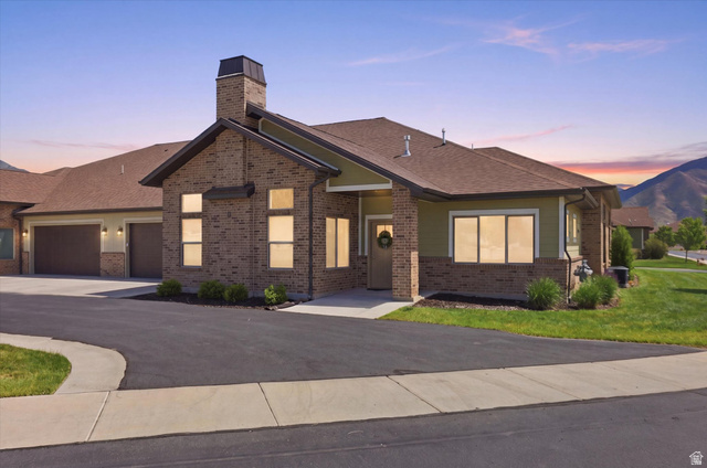 1838 West 300th Street South, Unit B Mapleton, UT 84664 - Photo 51 of 51 Brick and siding exterior featuring a prominent chimney structure and multiple windows