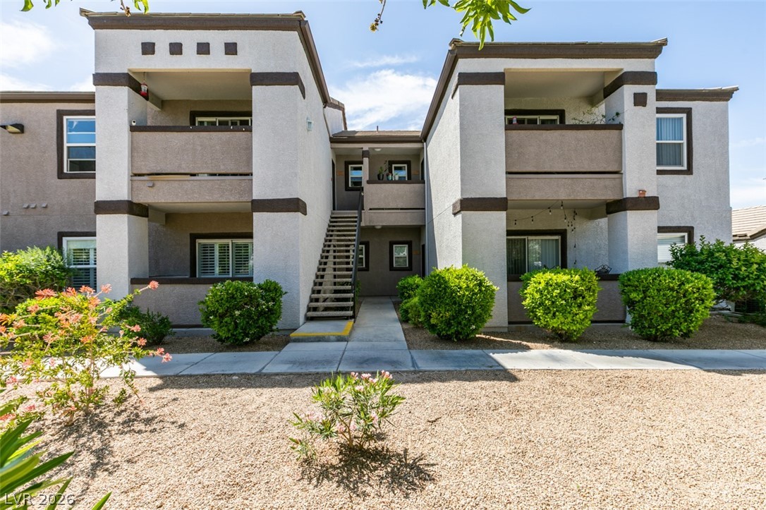 7255 West Sunset Road, Unit 1103 Las Vegas, NV 89113 - Photo 6 of 35 Clean lines define this multi-level condominium building, featuring balconies and a well-maintained entry with mature shrubs.