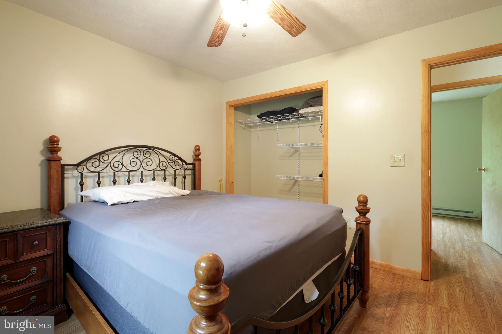 358 Buckridge Road Howard, PA 16841 - Photo 20 of 40 a bedroom with a bed and wooden floor