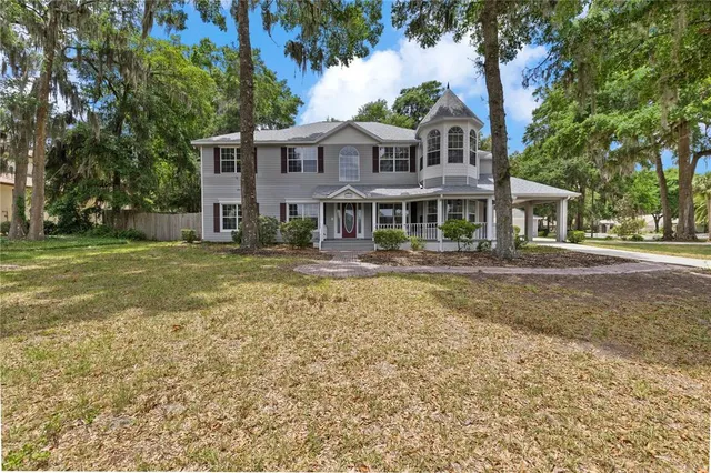 a view of a porch with wooden floor and floor to ceiling window
