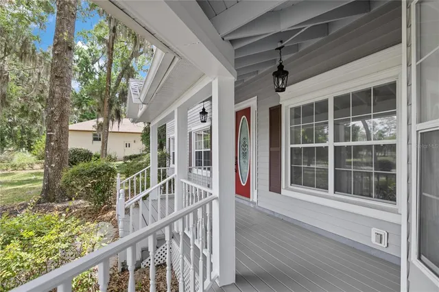 a view of a house with a yard and a large tree