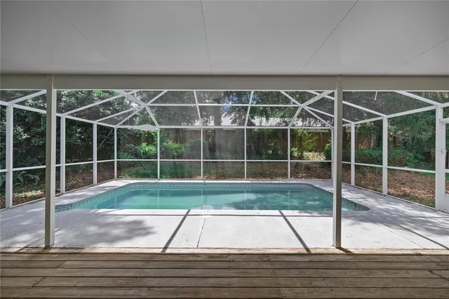 a view of a livingroom with wooden floor and stairs