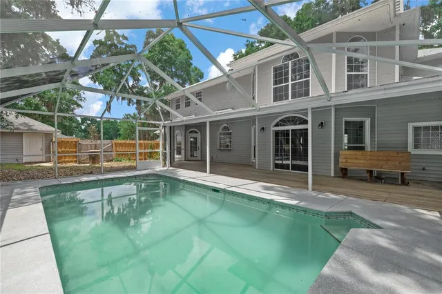 a view of a livingroom with wooden floor a fireplace and entryway