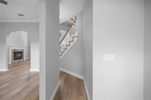 a kitchen with stainless steel appliances a refrigerator stove and white cabinets