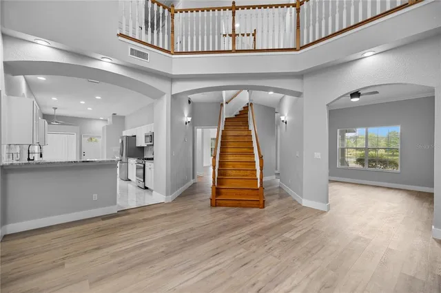 a view of empty room with wooden floor