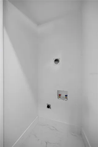 a view of empty room with windows and chandelier