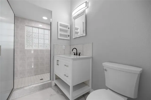 wooden floor in an empty room with a bathroom