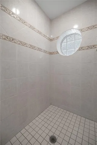 a living room with furniture a window and a potted plant