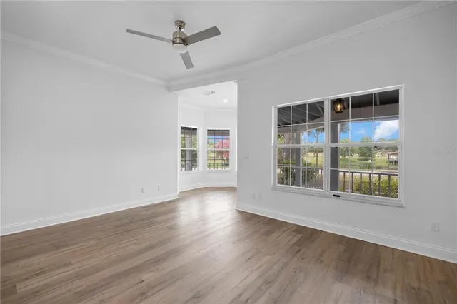 a view of a room with windows and wooden floor