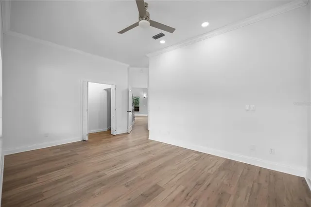 a view of empty room with wooden floor