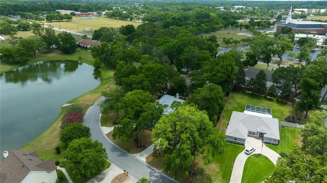an aerial view of residential house with outdoor space and lake view