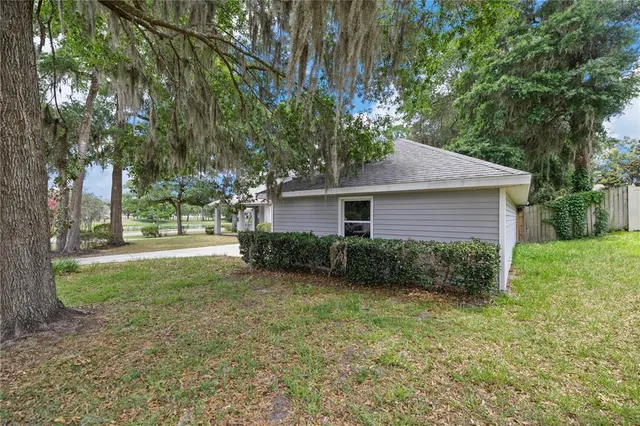 a view of a house with yard and a garden