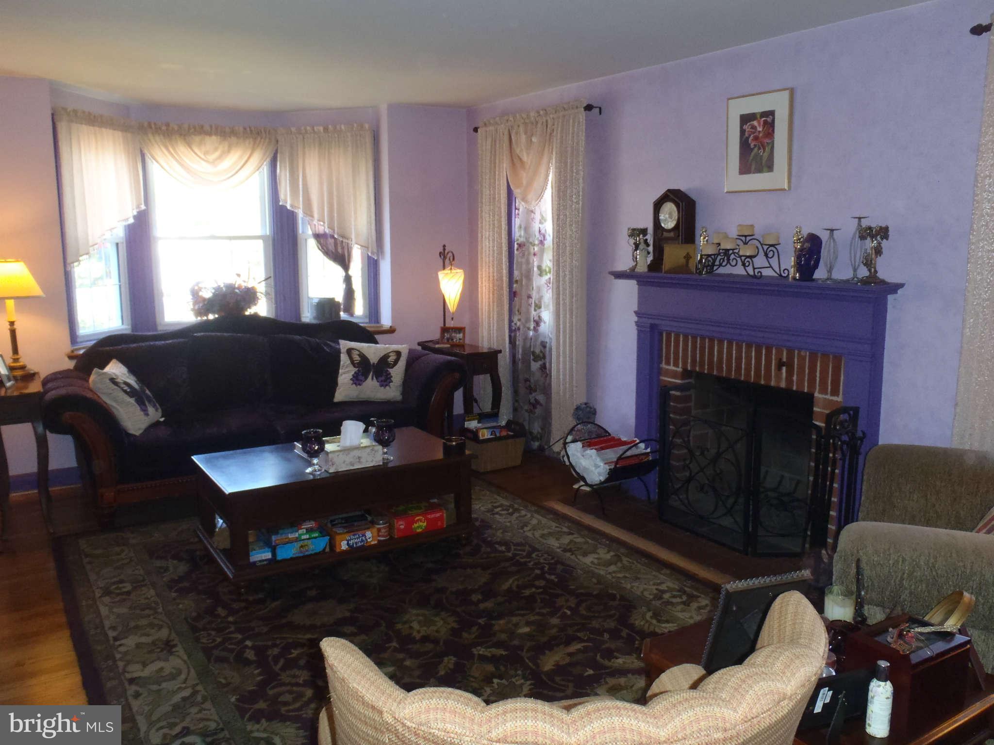 425 Lambeth Road Baltimore, MD 21228 - Photo 3 of 12 a living room with furniture and a fireplace